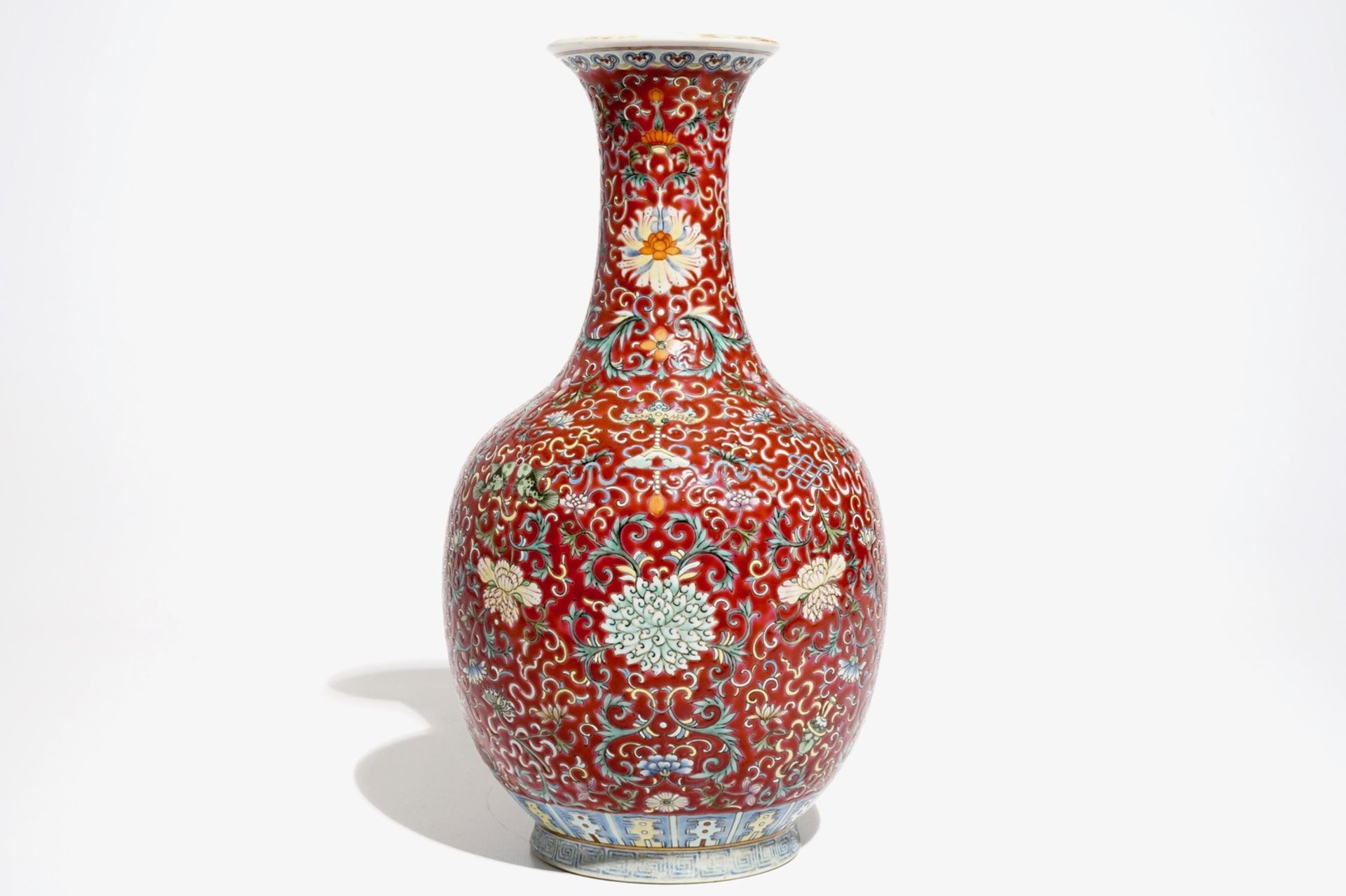 A Chinese red-ground famille rose bottle vase, Qianlong mark, 19/20th C. - Image 2 of 7