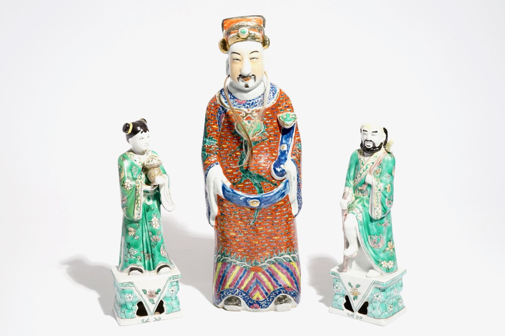 A Chinese famille rose figure of an immortal and a pair of famille verte figures, 19/20th C.