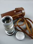 A LEITZ ELMAR F9CMS LENS with a Leica cap in a leather carry case