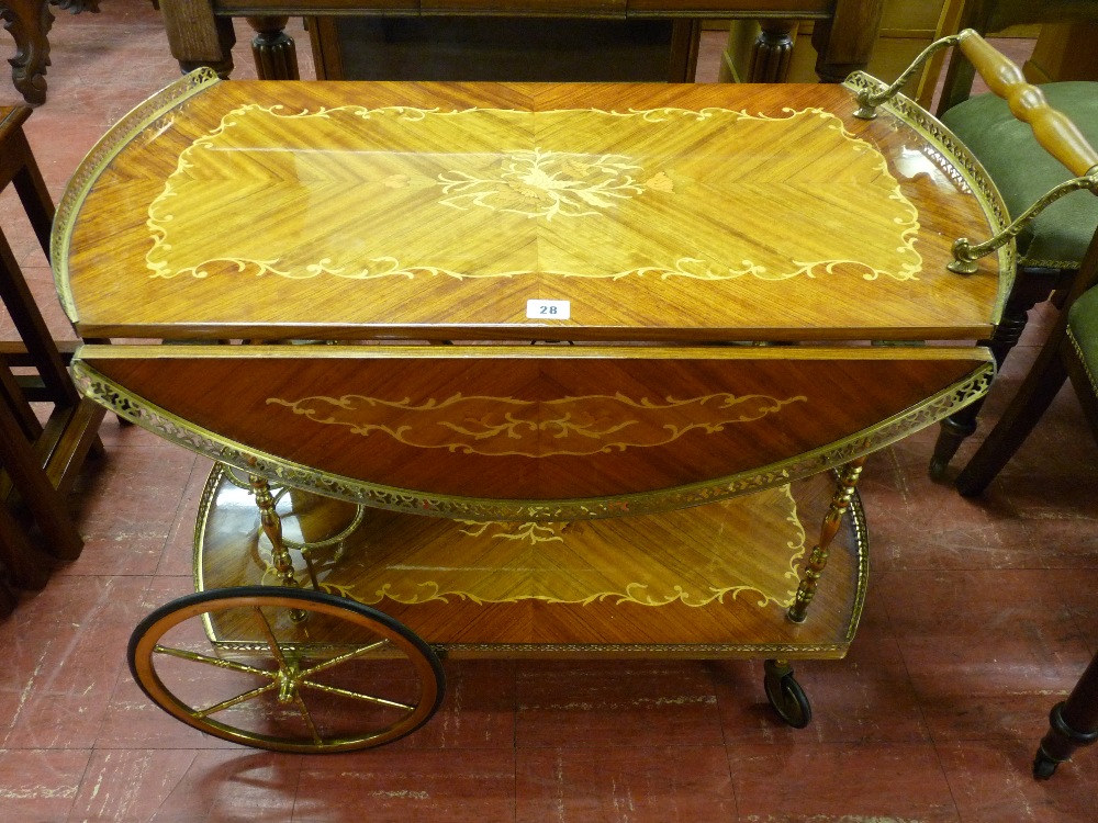 AN ITALIAN INLAID DRINK'S WAGON with twin flap brass gallery top and undershelf bottle storage on