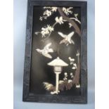 AN ORIENTAL SHIBAYAMA PANEL of birds and blossom over a thatched birdhouse set in a carved