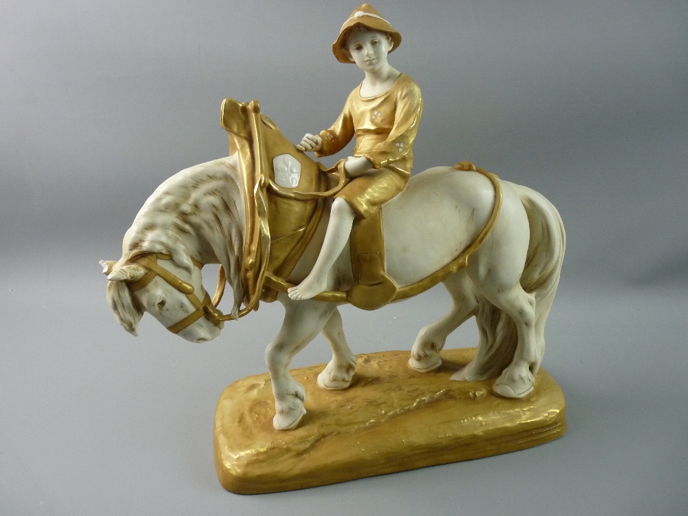 A ROYAL DUX FIGURE OF A YOUNG BOY on a plough horse, the porcelain decorated in muted ivory tones