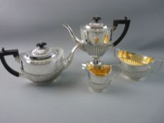 A SILVER TEA AND COFFEE SERVICE each piece of oval form with half reeded decoration to the bodies,