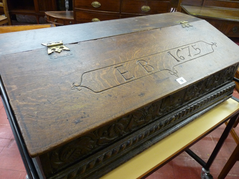 AN ANTIQUE OAK BIBLE/ALMS BOX, William III and later, the part sloping top with shaped brass