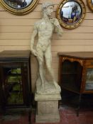 A MODERN COMPOSITE STATUE ON STAND, classical antiquities style figure of a young Greek man with fig