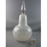 A LARGE ONION SHAPED CHEMIST'S DISPLAY BOTTLE having an oversized teardrop facet cut stopper with