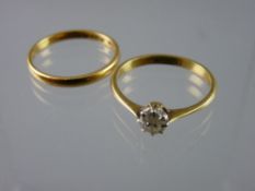 AN EIGHTEEN CARAT GOLD AND PLATINUM DIAMOND SOLITAIRE RING with a twenty two carat gold wedding
