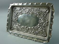 A HALLMARKED SILVER EMBOSSED TRAY, rectangular form with pinched edge and raised border with central
