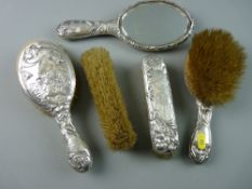 A HALLMARKED SILVER FIVE PIECE MIRROR AND BRUSH SET with embossed Art Nouveau pattern of maiden's