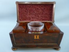 A VICTORIAN SARCOPHAGUS SHAPED WALNUT TEA CADDY with beaded decoration on turned bun feet, the