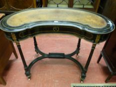 AN EBONIZED AND BRASS STRUNG KIDNEY SHAPED WRITING DESK, circa 1880 with brown tooled leather top