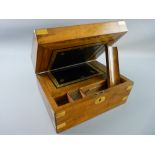 A VICTORIAN WALNUT WRITING SLOPE with brass banding and escutcheon, the interior with black gilt