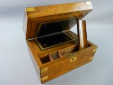 A VICTORIAN WALNUT WRITING SLOPE with brass banding and escutcheon, the interior with black gilt