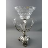 A WALKER & HALL ELECTROPLATED TABLE CENTREPIECE, the segmented trefoil base with shell foot and