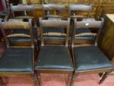 A SET OF SIX REGENCY MAHOGANY DINING CHAIRS, the curved top rail with carved decoration, central