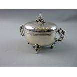 A CONTINENTAL WHITE METAL SUGAR BOX AND COVER, the hinged and engraved lid with Rococo finial,