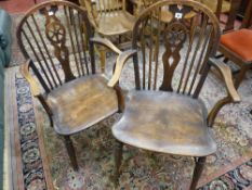 TWO 19th CENTURY ELM WHEELBACK OPEN ARMCHAIRS, 93.5 cms high the largest, 57 cms wide (worm