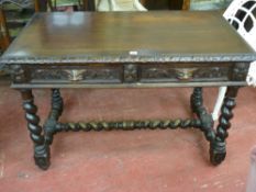 A VICTORIAN CARVED OAK SIDE TABLE, the crossbanded top with carved moulded edge, twin mask handled