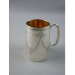 A HALLMARKED SILVER CHRISTENING TANKARD, engraved with foliate ribbon tied swags, 8.75 cms high,