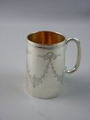 A HALLMARKED SILVER CHRISTENING TANKARD, engraved with foliate ribbon tied swags, 8.75 cms high,