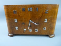 A GOOD WALNUT CASED ART DECO CHIMING MANTEL CLOCK having stylized chrome numerals and hands, the