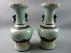 A PAIR OF ORIENTAL CELADON CRACKLE GLAZED NARROW NECKED BULBOUS VASES with elephant trunk handles