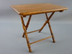 AN EARLY TO MID 20th CENTURY POLISHED FOLDING MINIATURE TABLE having an oblong top and with bamboo