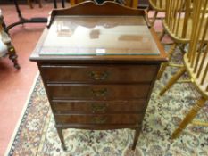 AN EDWARDIAN MAHOGANY MUSIC CABINET with galleried top and four drop down front sheet music