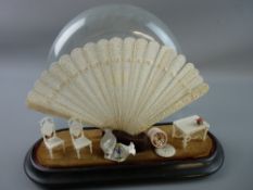 A 19th CENTURY CARVED CHINESE IVORY FAN and a group of Napoleonic carved bone miniatures, the