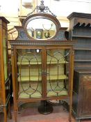 AN EXCELLENT CIRCA 1900 MAHOGANY DISPLAY CABINET, the oval mirrored top rail with urn and swag