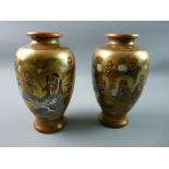 A PAIR OF MEIJI PERIOD JAPANESE SATSUMA VASES depicting immortals with intertwined pearl dragon
