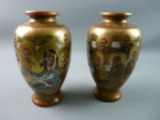 A PAIR OF MEIJI PERIOD JAPANESE SATSUMA VASES depicting immortals with intertwined pearl dragon