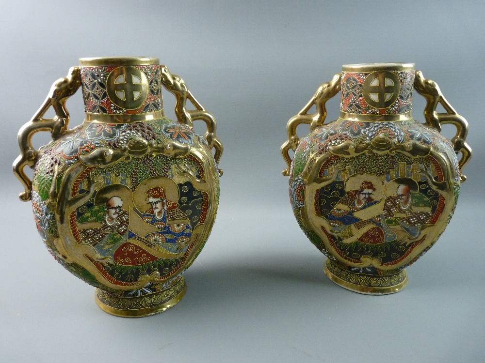 A PAIR OF 20th CENTURY JAPANESE SATSUMA VASES having all over raised enamel and gilt decoration