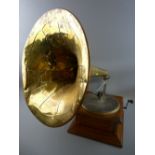 AN OAK CASED VINTAGE WIND-UP GRAMOPHONE with large brass horn, trade stamped to the front '