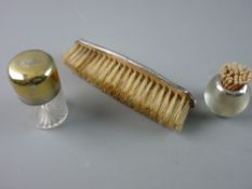 A CYLINDRICAL GLASS SMELLING SALTS BOTTLE with a deep silver hinged lid and silver band, London