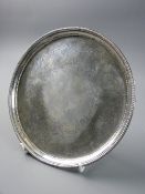 A GEORGE III SILVER CARD TRAY, 17.75 cms diameter with beadwork border and floral engraved tray on