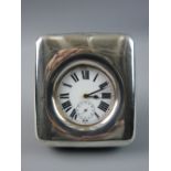 A PLAIN SILVER FRAMED TRAVELLING CLOCK with white enamel dial, Roman numerals and sweep seconds