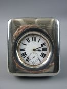 A PLAIN SILVER FRAMED TRAVELLING CLOCK with white enamel dial, Roman numerals and sweep seconds