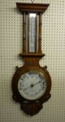 AN OAK FRAMED ANEROID BAROMETER WITH THERMOMETER, the dial marked 'W Williams Jones, Carnarvon',