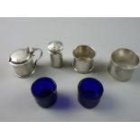 A SET OF THREE PLAIN SILVER CAPSTAN SHAPED CONDIMENTS, the mustard and salt pots with Bristol blue