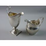 TWO GEORGIAN SILVER CREAM JUGS with London hallmarks, a 15.5 cms high helmet shaped jug with