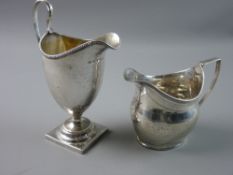 TWO GEORGIAN SILVER CREAM JUGS with London hallmarks, a 15.5 cms high helmet shaped jug with