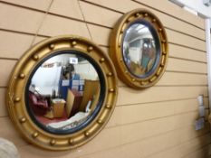 TWO REGENCY STYLE CONVEX WALL MIRRORS, circular with ball decoration and ebonized inner slip, 43 cms