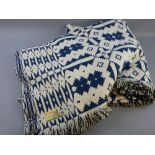 A LARGE WELSH WOOLLEN DOUBLE BEDSPREAD with original label, blue and cream reverse patterned, the