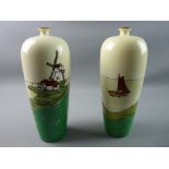 A PAIR OF ARTS & CRAFTS STYLE BALUSTER VASES, hand painted on a cream ground showing a coastal