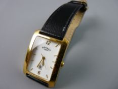 A GENT'S OBLONG DIAL YELLOW METAL ROTARY QUARTZ CALENDAR WRISTWATCH with black leather strap