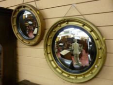TWO REGENCY STYLE CONVEX WALL MIRRORS, circular with ball decoration and ebonized slip, 54 and 43