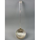 A FINE SILVER SOUP LADLE, the 9 cms bowl of shell form and the tapered handle having feather