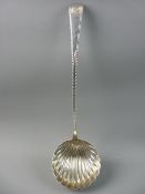 A FINE SILVER SOUP LADLE, the 9 cms bowl of shell form and the tapered handle having feather