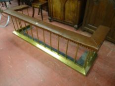 A BRASS CLUB FENDER, brown padded top with brass buttoning, plain gallery spindles on a chamfered